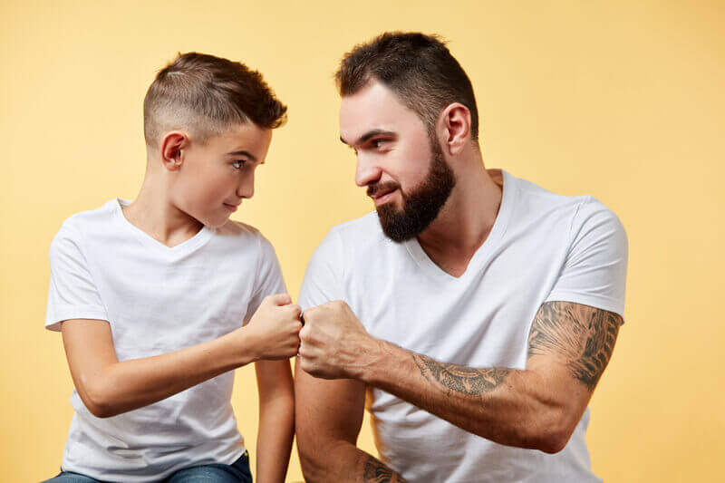 Father and kid fisting bump